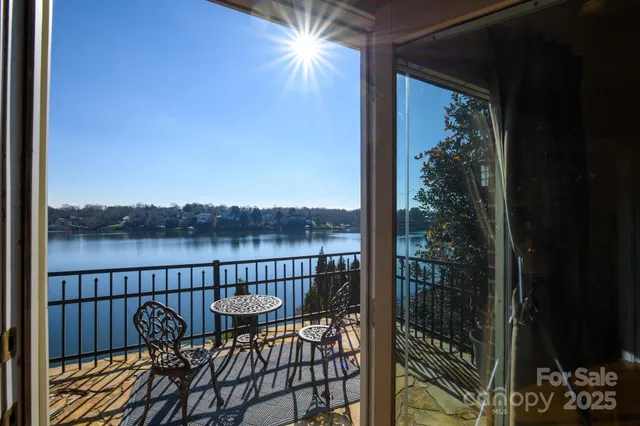 a view of a lake with couches chairs