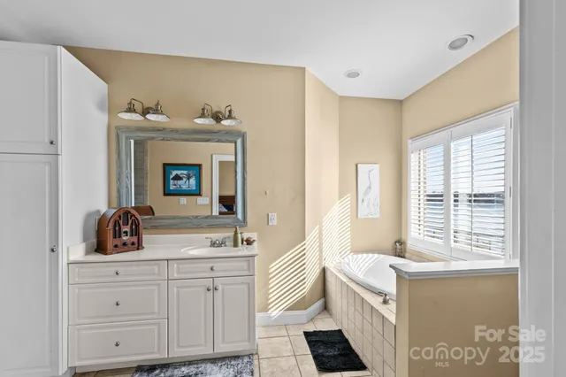 a bathroom with a double vanity sink mirror and shower
