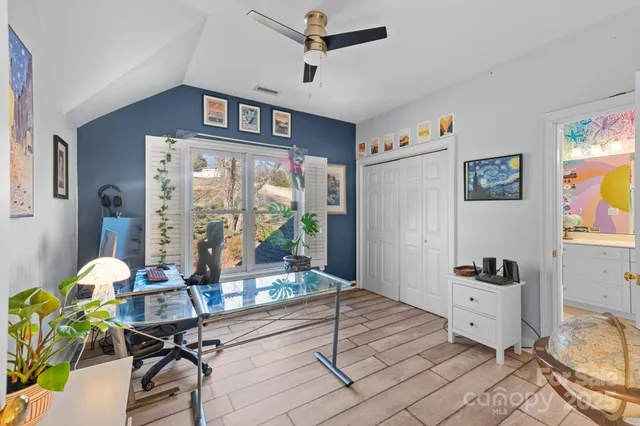 a bedroom with furniture and a wooden floor