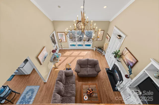 a living room with furniture a fireplace and a floor to ceiling window