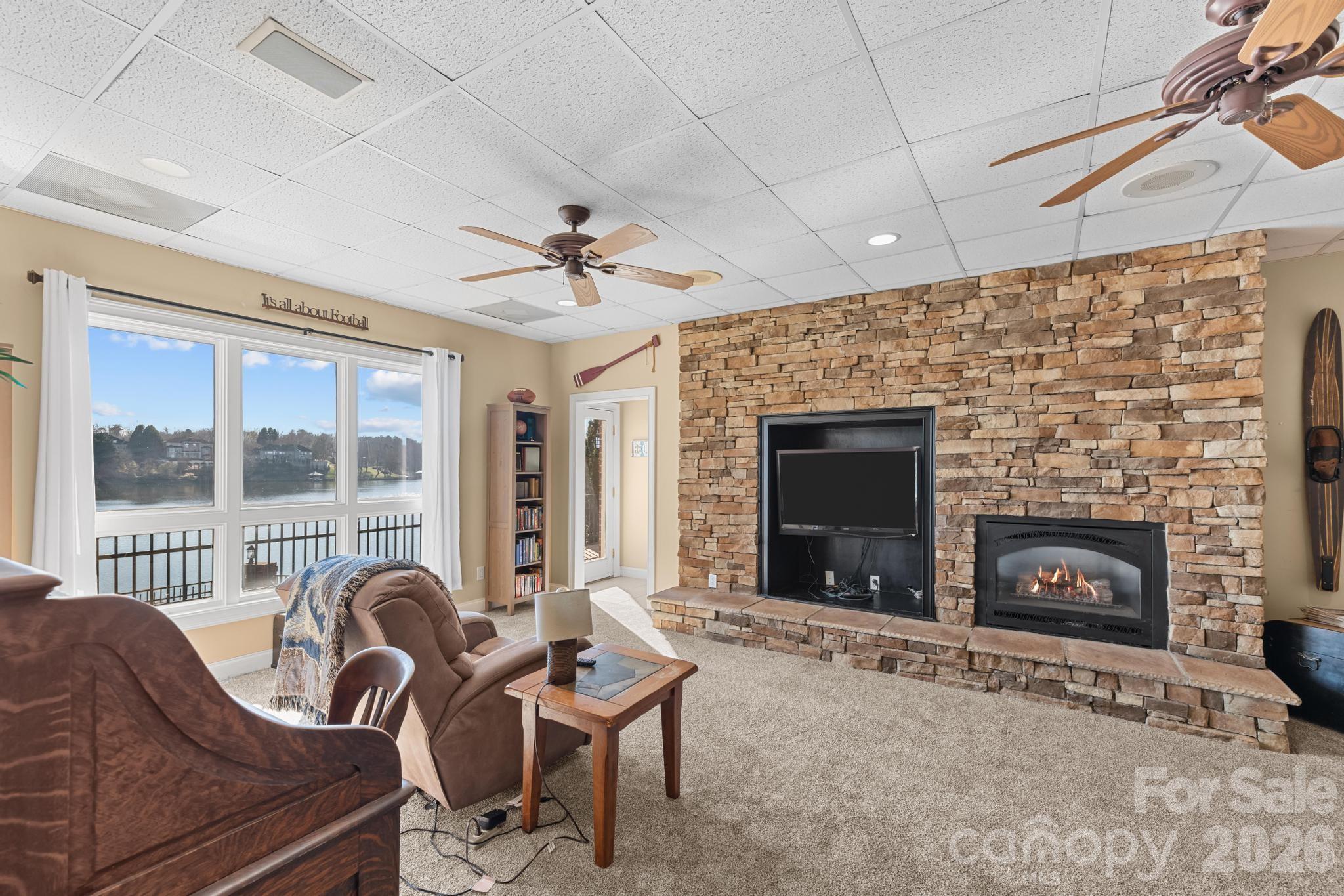 121 Pleasant Point Drive Hickory, NC 28601 - Photo 29 of 46 a living room with furniture a fireplace and a floor to ceiling window