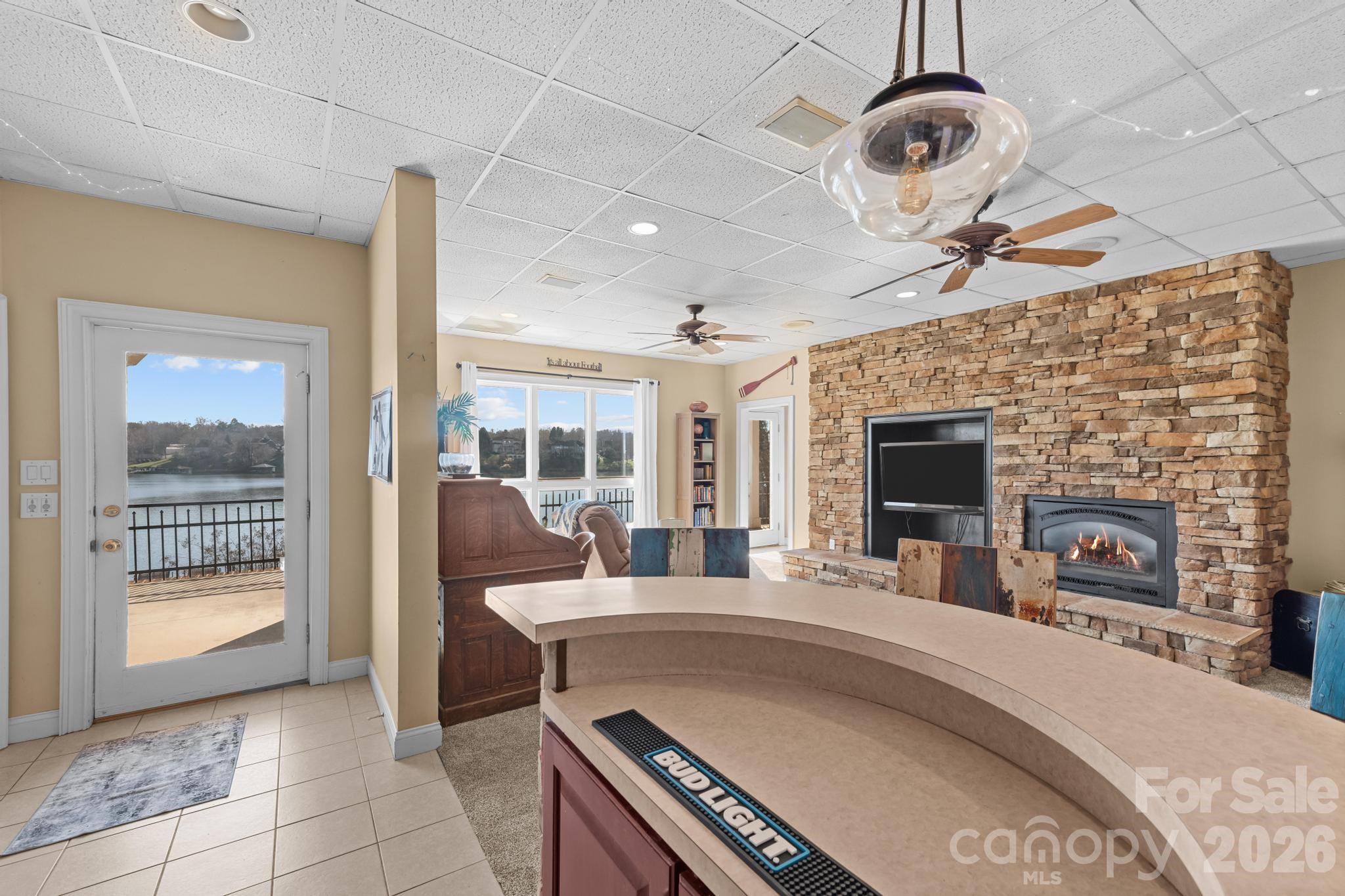 121 Pleasant Point Drive Hickory, NC 28601 - Photo 31 of 46 a living room with furniture a fireplace and a floor to ceiling window