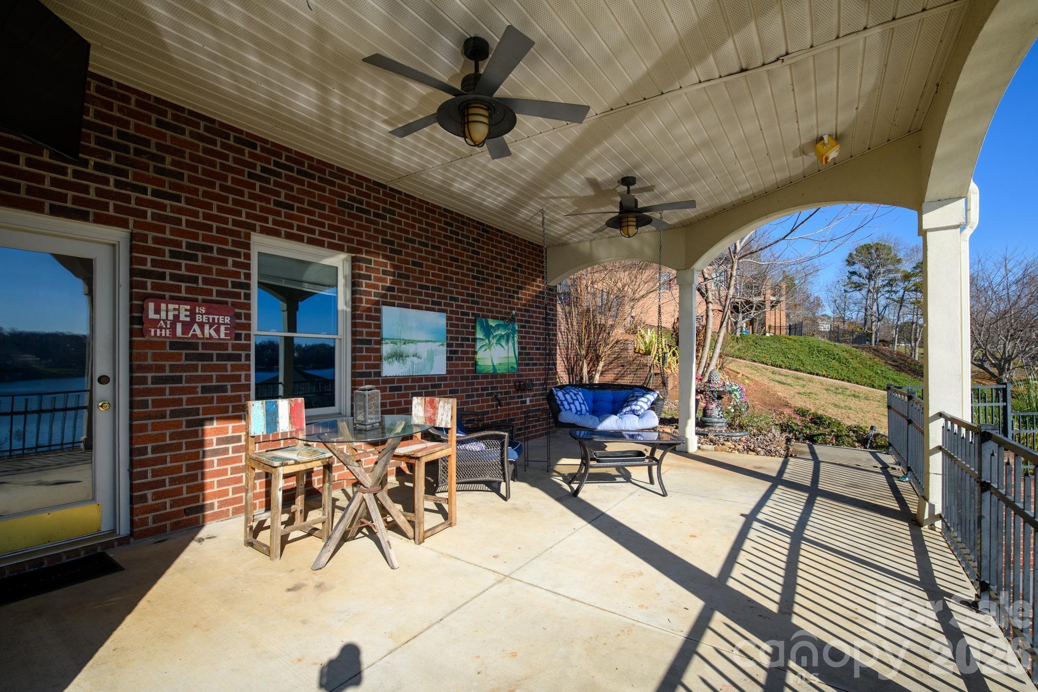 121 Pleasant Point Drive Hickory, NC 28601 - Photo 37 of 46 a view of a patio with table and chairs potted plants with wooden floor
