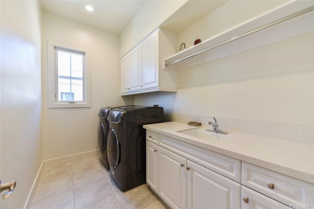 61 Buttonquail Irvine, CA 92618 - Photo 18 of 50 a utility room with sink dryer and washer