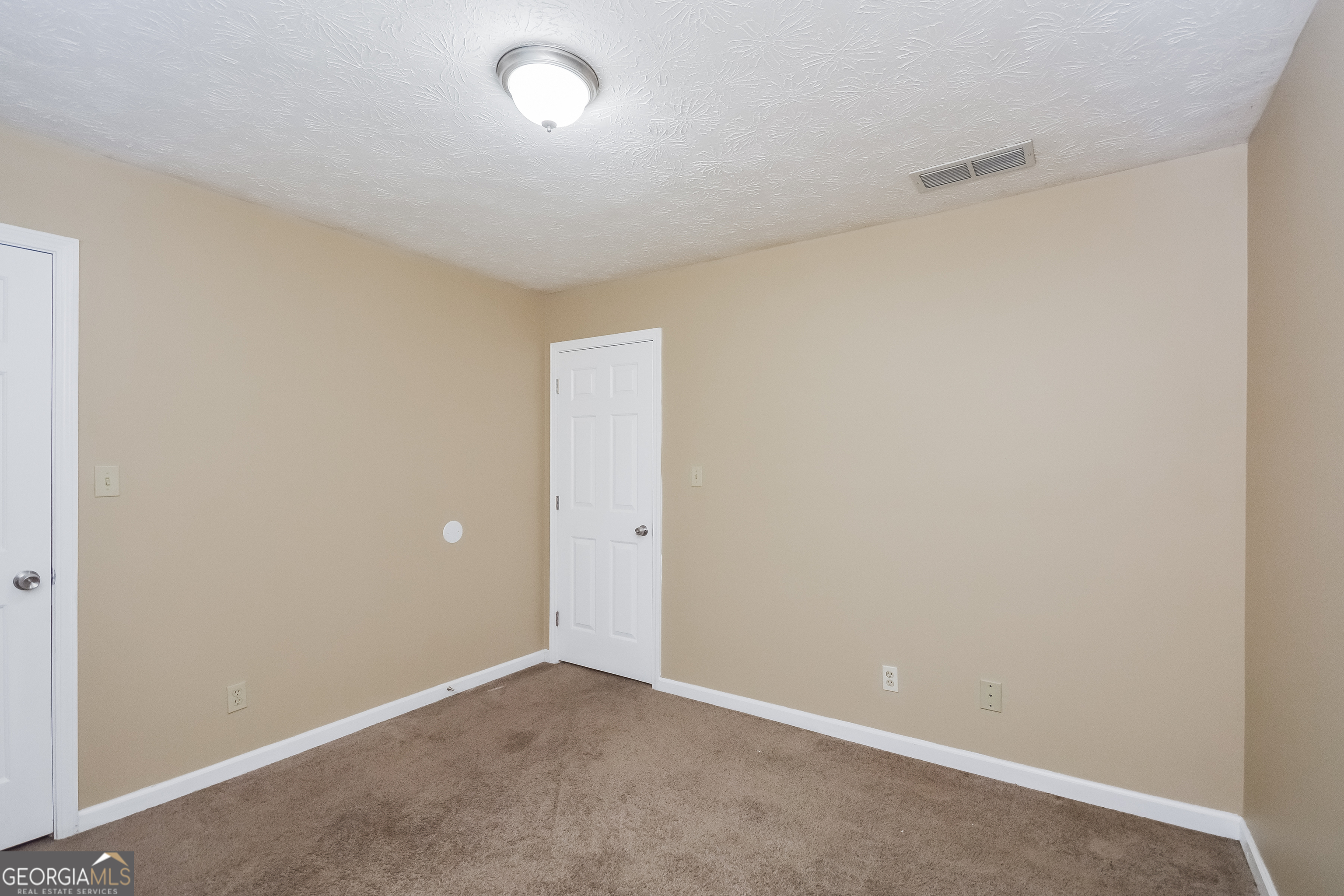 2451 Sherrie Lane Southwest Conyers, GA 30094 - Photo 11 of 17 a view of an empty room