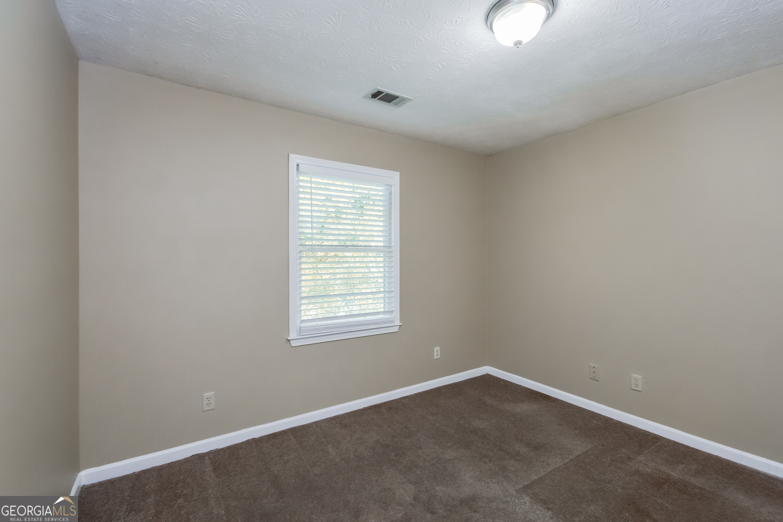 2451 Sherrie Lane Southwest Conyers, GA 30094 - Photo 12 of 17 an empty room with windows