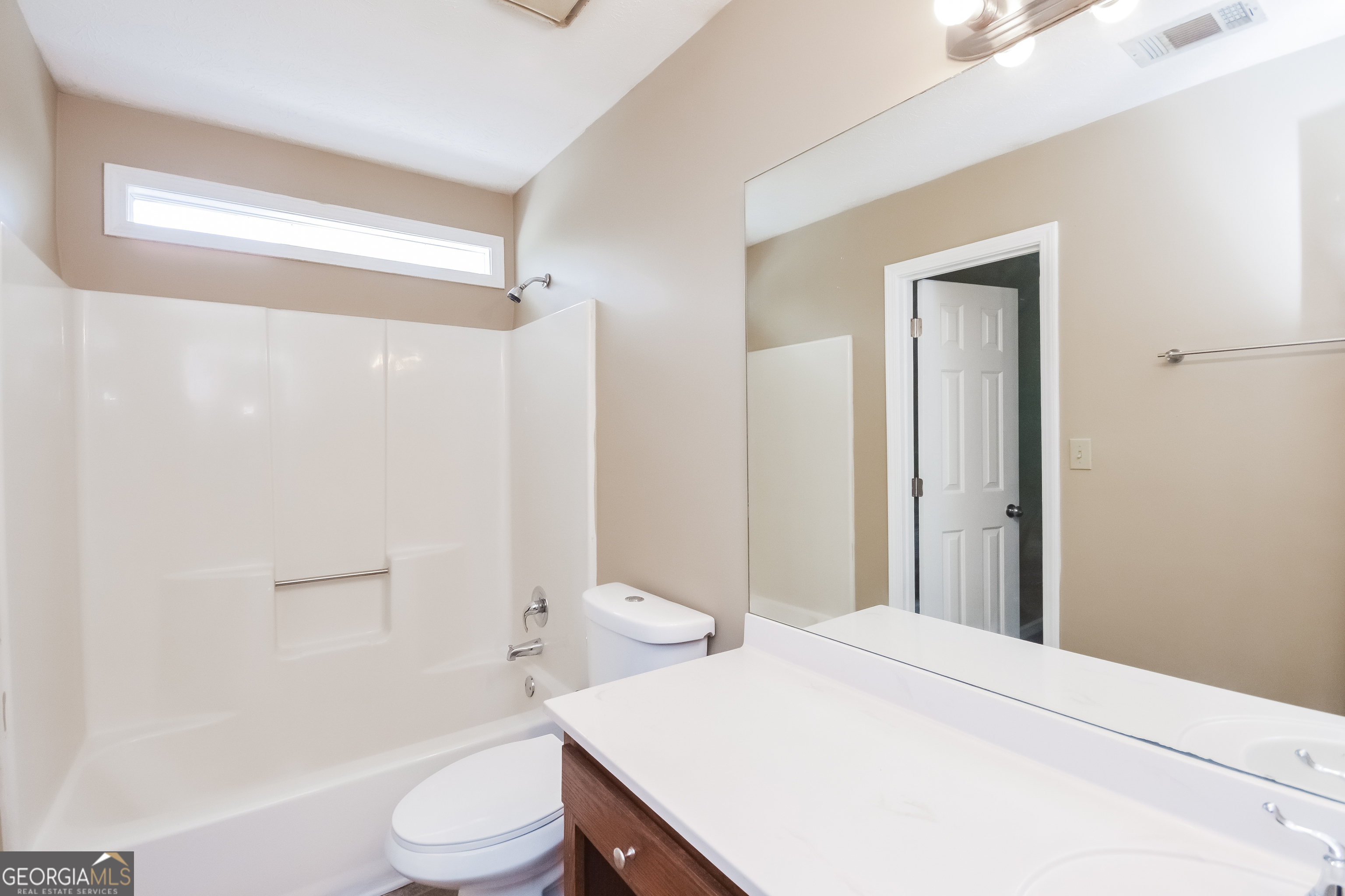 2451 Sherrie Lane Southwest Conyers, GA 30094 - Photo 14 of 17 a bathroom with a sink a toilet and shower
