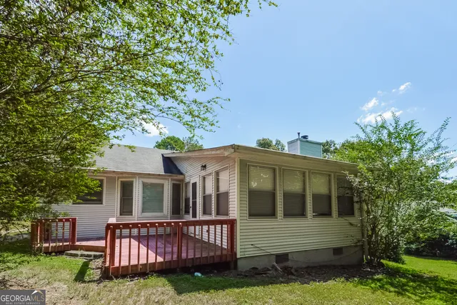a view of a house with a yard and sitting area