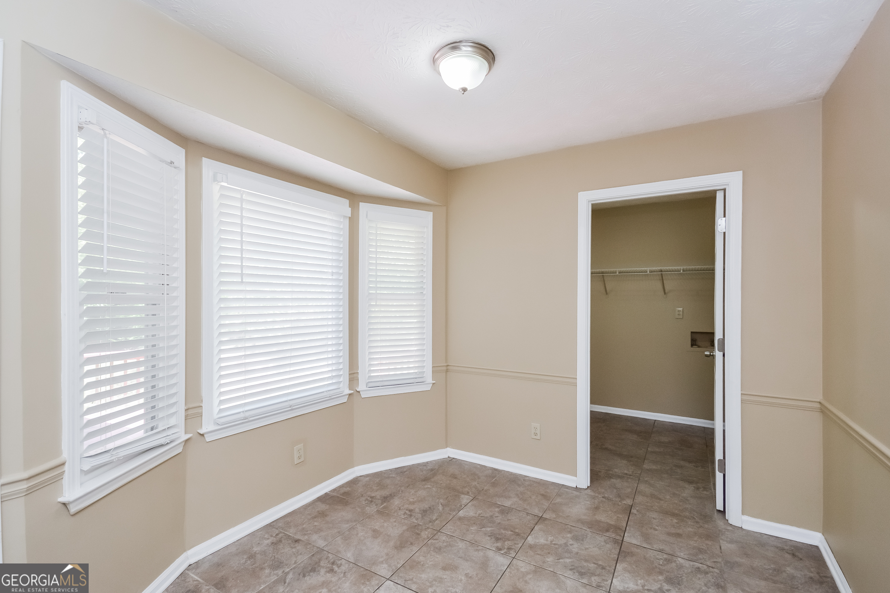 2451 Sherrie Lane Southwest Conyers, GA 30094 - Photo 6 of 17 a view of an empty room with a window