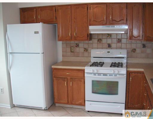 2004 Timber Oaks Road Edison, NJ 08820 - Photo 3 of 10 a white refrigerator freezer sitting inside of a kitchen