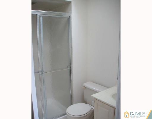 2004 Timber Oaks Road Edison, NJ 08820 - Photo 7 of 10 a white toilet sitting next to a shower