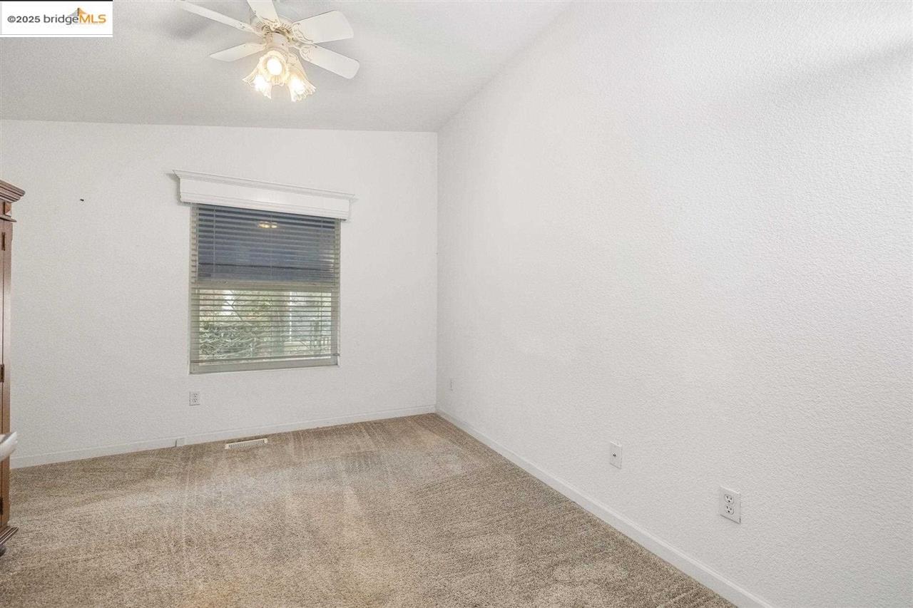 18717 Mill Villa Road, Unit 612 Jamestown, CA 95327 - Photo 11 of 22 an empty room with a fan & a window