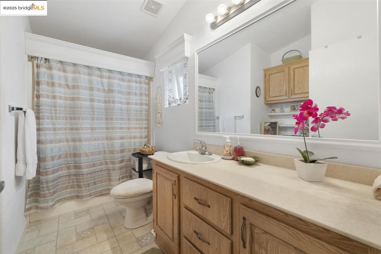 18717 Mill Villa Road, Unit 612 Jamestown, CA 95327 - Photo 14 of 22 a bathroom with a granite countertop sink mirror and toilet