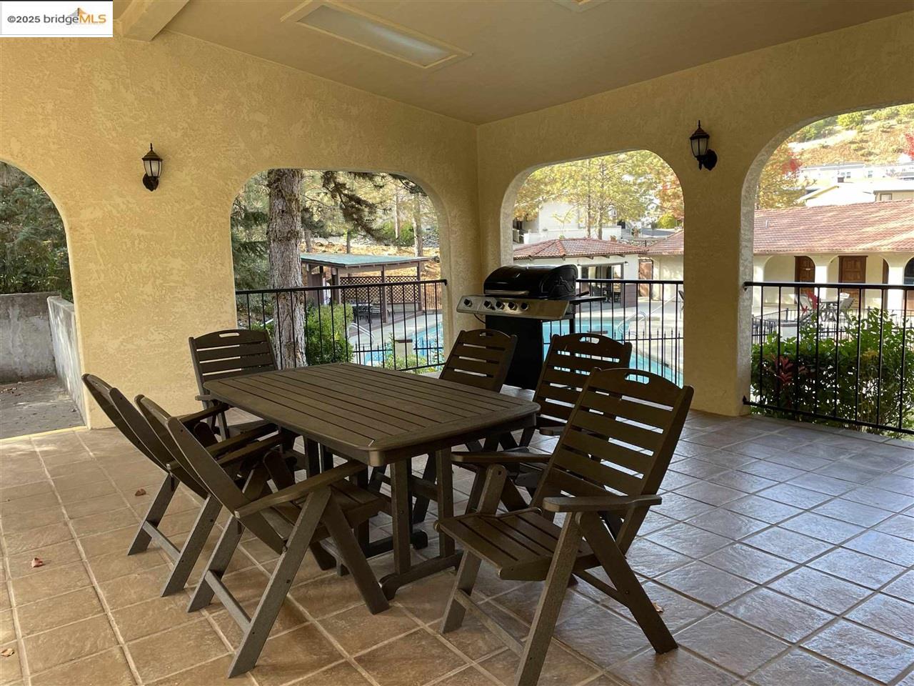18717 Mill Villa Road, Unit 612 Jamestown, CA 95327 - Photo 21 of 22 a view of a patio with table and chairs with wooden floor and fence