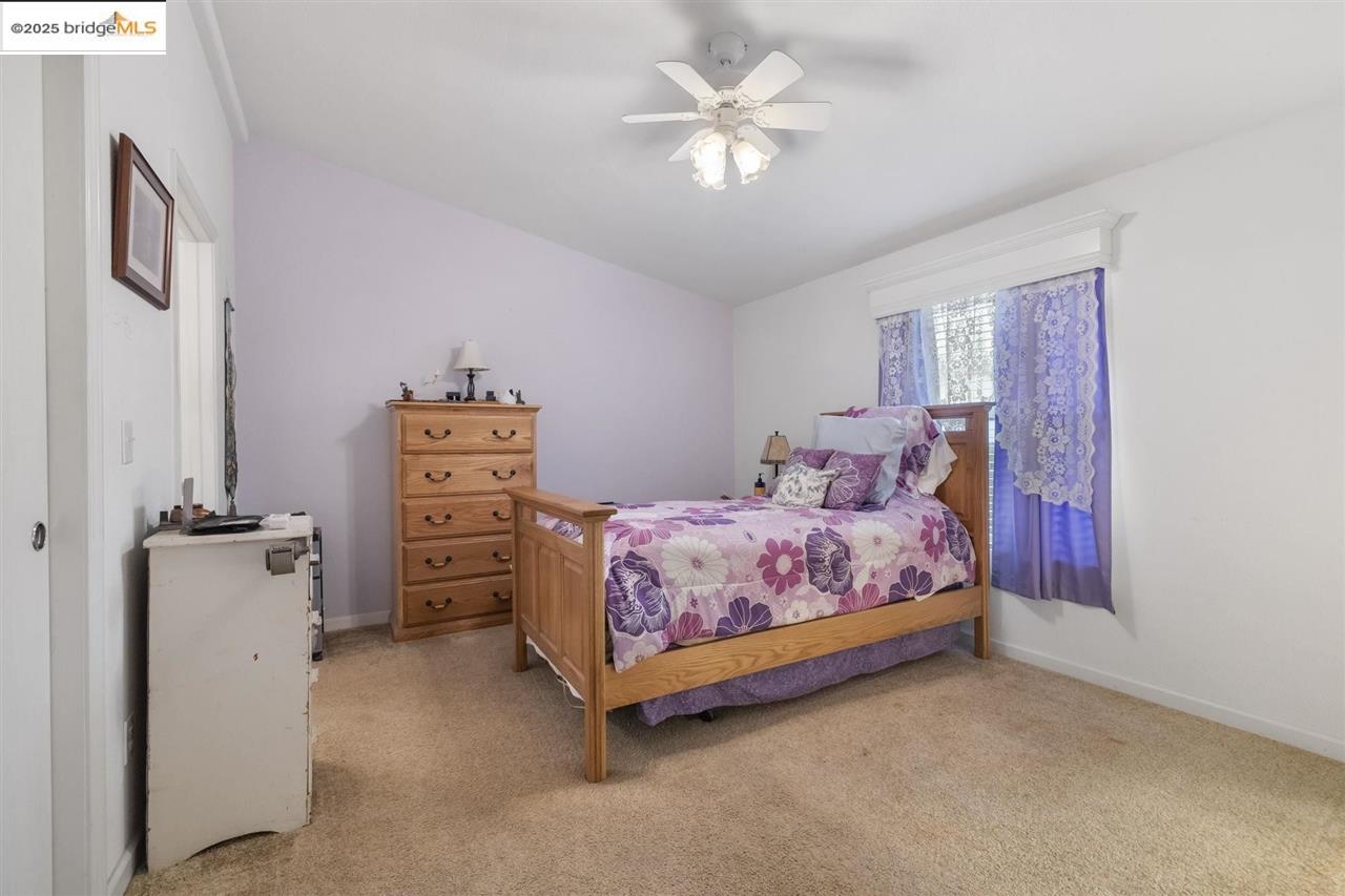 18717 Mill Villa Road, Unit 612 Jamestown, CA 95327 - Photo 21 of 22 a bedroom with a bed and a chandelier