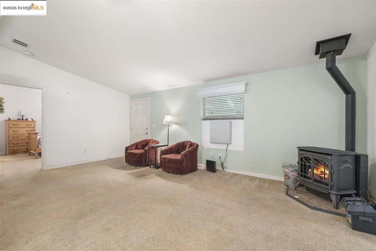 18717 Mill Villa Road, Unit 612 Jamestown, CA 95327 - Photo 4 of 22 a spacious bedroom with a bed and a fireplace