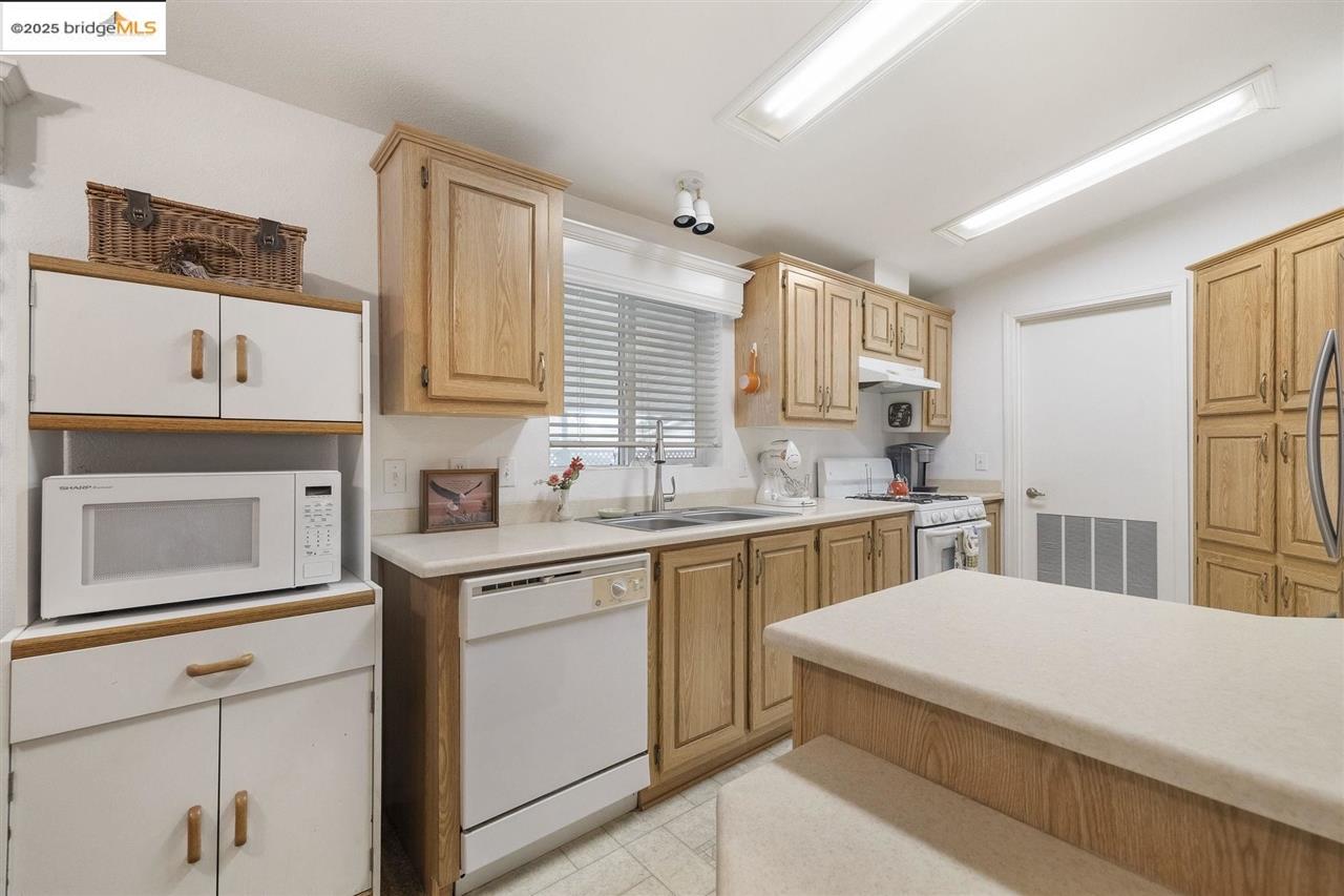 18717 Mill Villa Road, Unit 612 Jamestown, CA 95327 - Photo 7 of 22 a kitchen with a sink stove and cabinets