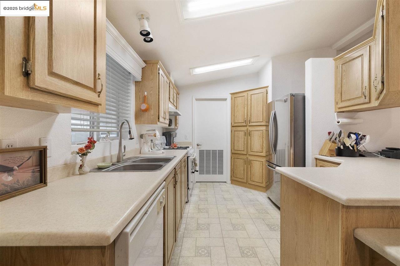 18717 Mill Villa Road, Unit 612 Jamestown, CA 95327 - Photo 8 of 22 a kitchen with a sink a stove and refrigerator