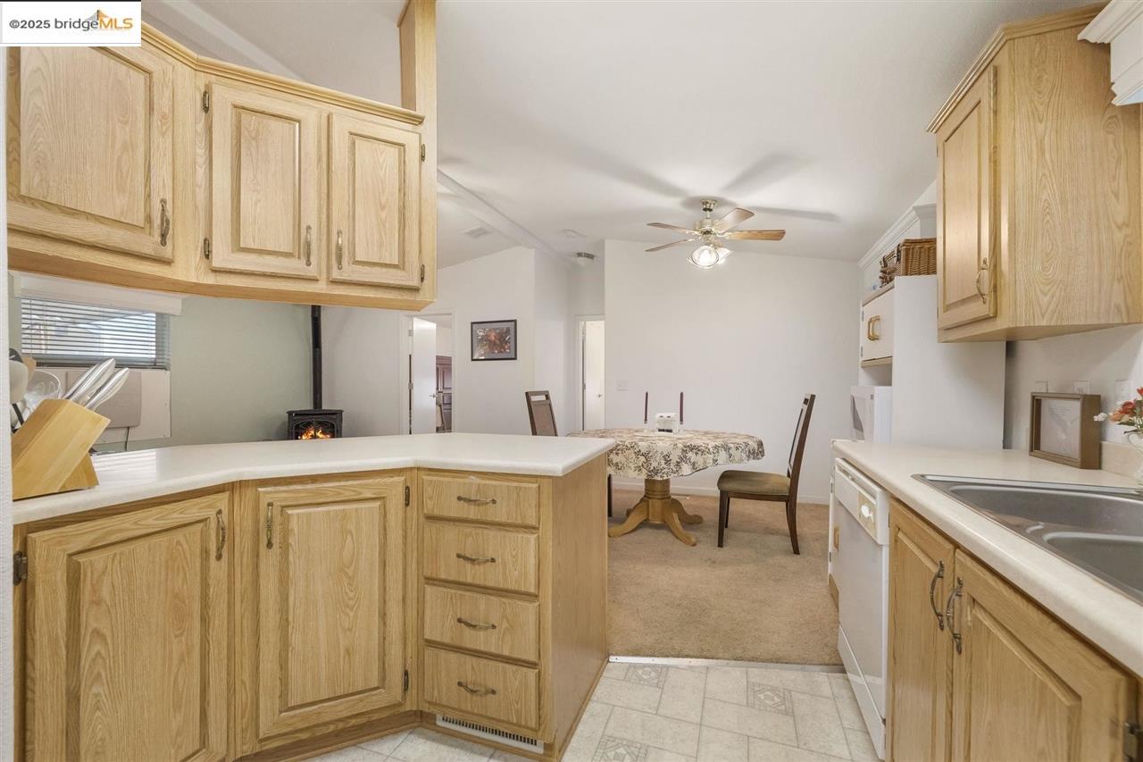 18717 Mill Villa Road, Unit 612 Jamestown, CA 95327 - Photo 9 of 22 a kitchen with cabinets appliances and a sink