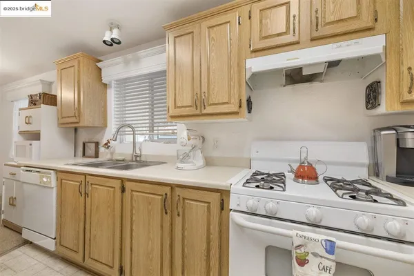 a kitchen with stainless steel appliances granite countertop a sink stove and cabinets