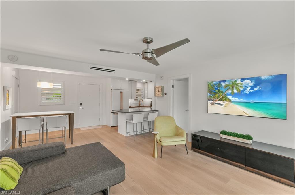 568 12th Avenue South, Unit 568 Naples, FL 34102 - Photo 11 of 34 a living room with furniture and a table
