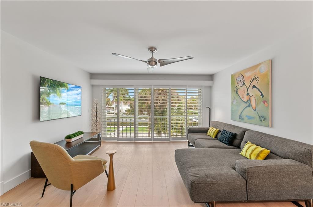 568 12th Avenue South, Unit 568 Naples, FL 34102 - Photo 12 of 34 a living room with furniture and a large window