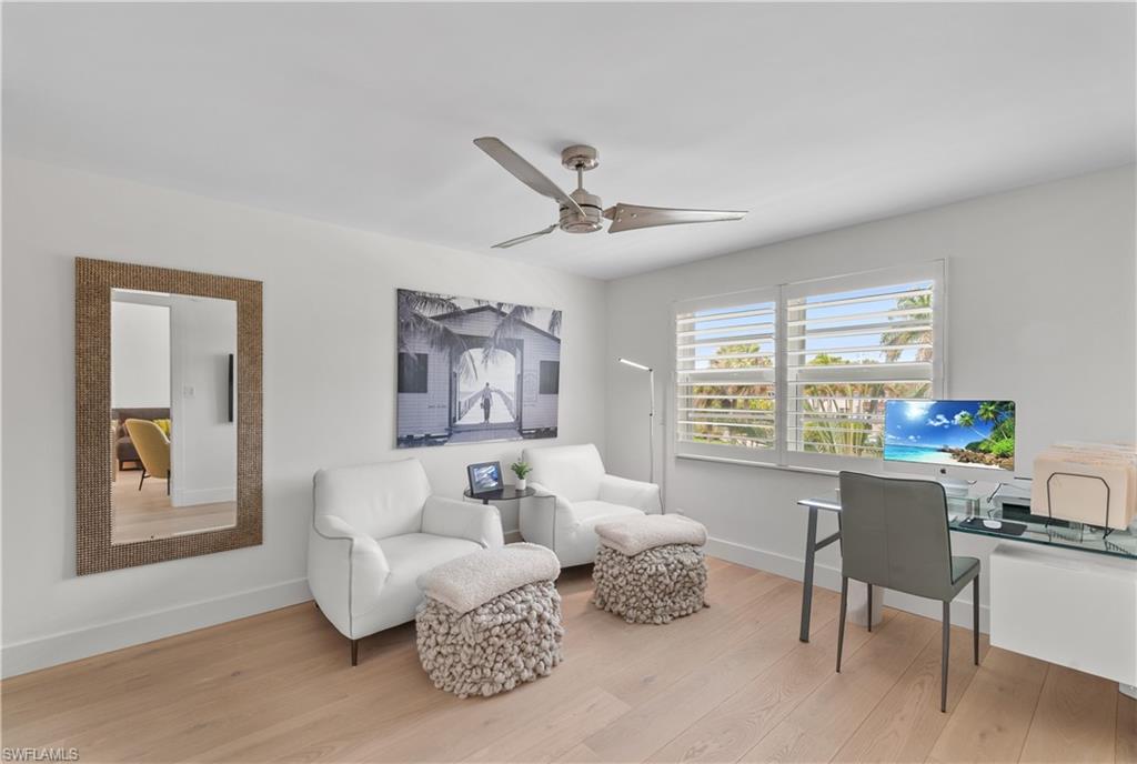 568 12th Avenue South, Unit 568 Naples, FL 34102 - Photo 13 of 34 a living room with furniture and a large window