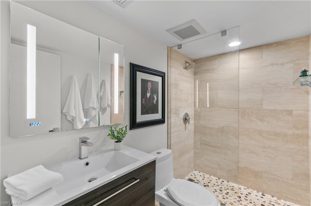568 12th Avenue South, Unit 568 Naples, FL 34102 - Photo 15 of 34 a bathroom with a sink toilet and shower