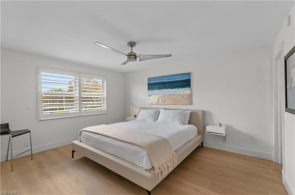568 12th Avenue South, Unit 568 Naples, FL 34102 - Photo 17 of 34 a bedroom with a bed and a window