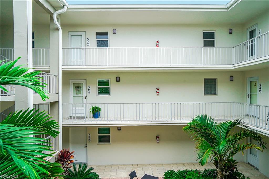 568 12th Avenue South, Unit 568 Naples, FL 34102 - Photo 24 of 34 a front view of a house with plants