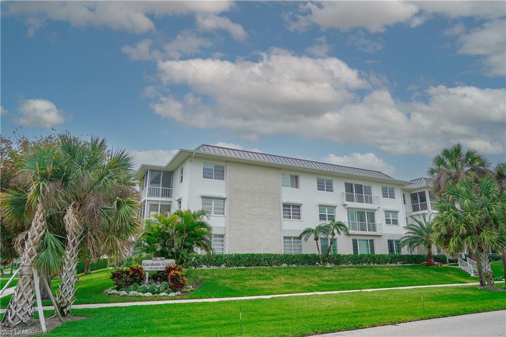 568 12th Avenue South, Unit 568 Naples, FL 34102 - Photo 27 of 34 a front view of a house with a garden