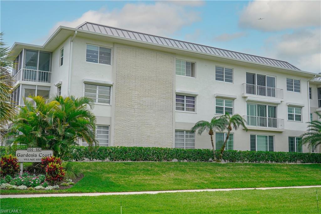568 12th Avenue South, Unit 568 Naples, FL 34102 - Photo 28 of 34 a front view of a house with a yard