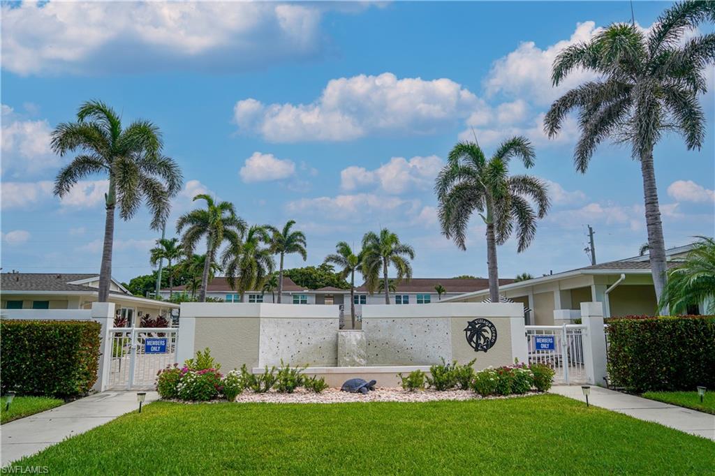568 12th Avenue South, Unit 568 Naples, FL 34102 - Photo 29 of 34 a front view of a house with garden and palm tree