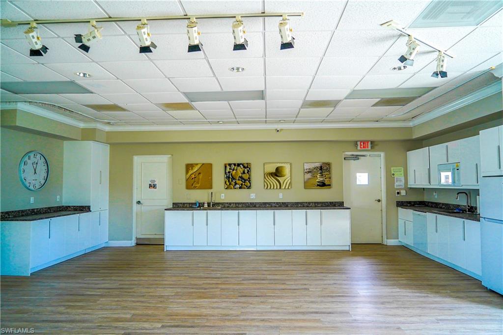 568 12th Avenue South, Unit 568 Naples, FL 34102 - Photo 31 of 34 a view of a kitchen with refrigerator and stove