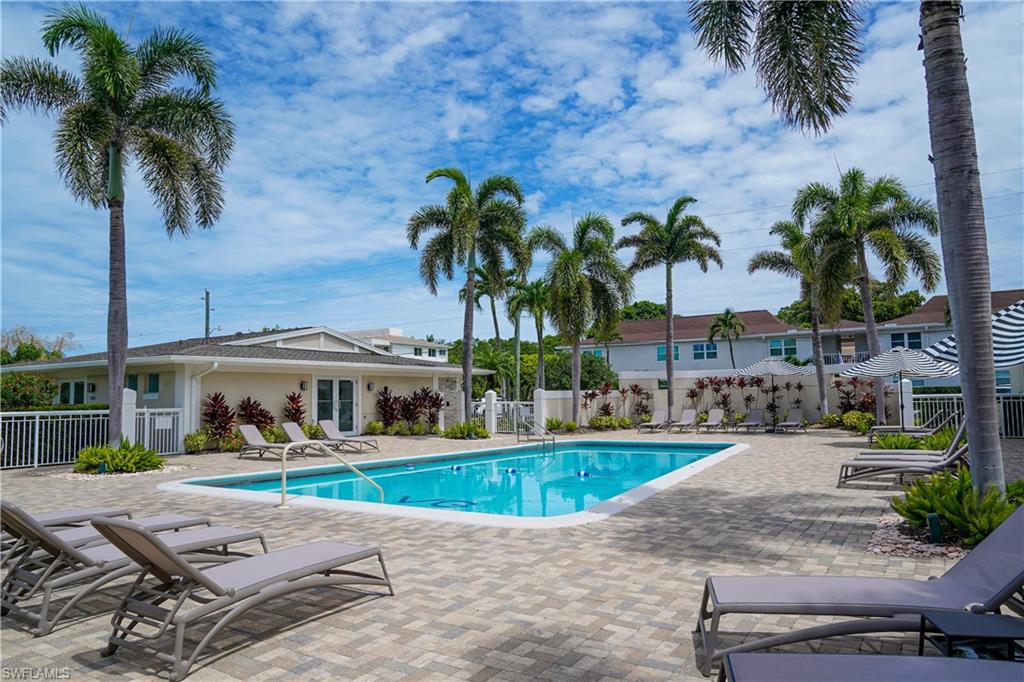 568 12th Avenue South, Unit 568 Naples, FL 34102 - Photo 33 of 34 a front view of multiple houses with yard