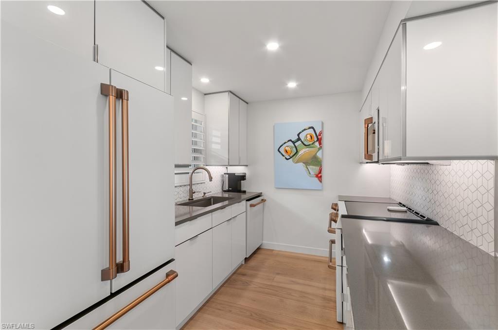 568 12th Avenue South, Unit 568 Naples, FL 34102 - Photo 6 of 34 a kitchen with stainless steel appliances granite countertop a refrigerator and a sink