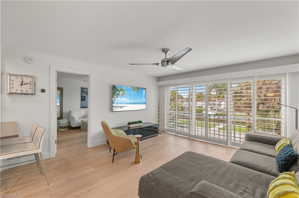 568 12th Avenue South, Unit 568 Naples, FL 34102 - Photo 8 of 34 a living room with furniture and a large window