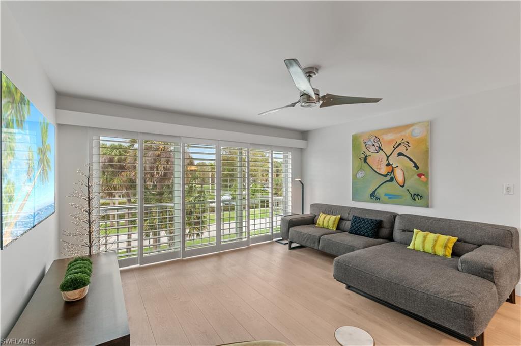 568 12th Avenue South, Unit 568 Naples, FL 34102 - Photo 9 of 34 a living room with furniture and a large window