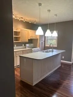 a view of a room with an empty space and wooden floor
