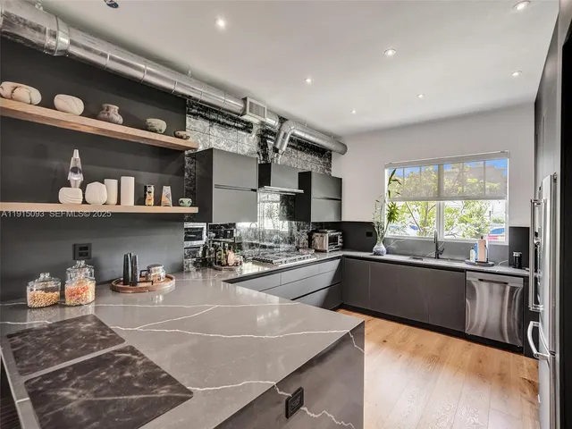 a kitchen with stainless steel appliances granite countertop a sink and cabinets