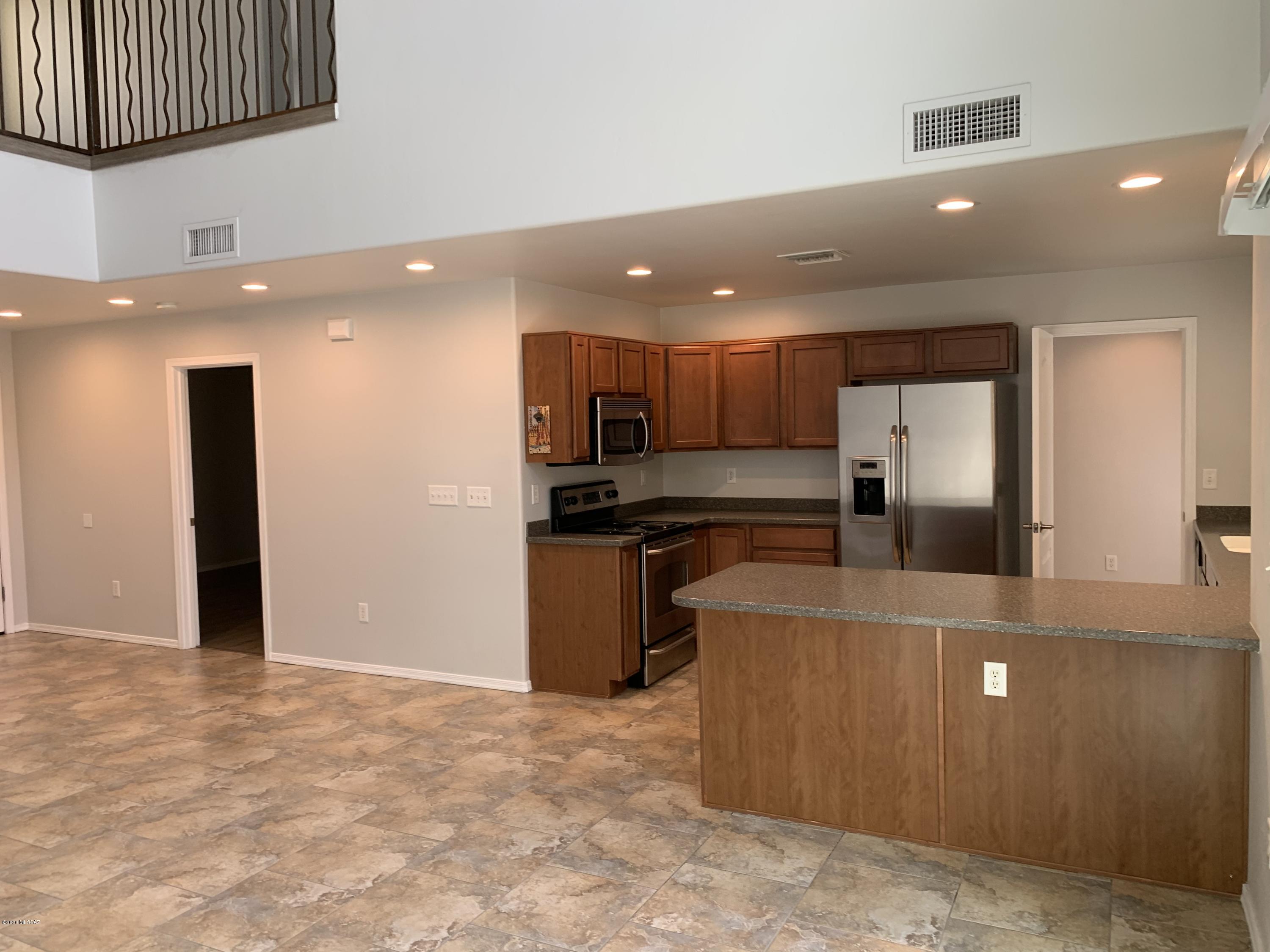 4181 North Fortune Loop Tucson, AZ 85719 - Photo 9 of 39 a view of kitchen with refrigerator and a sink