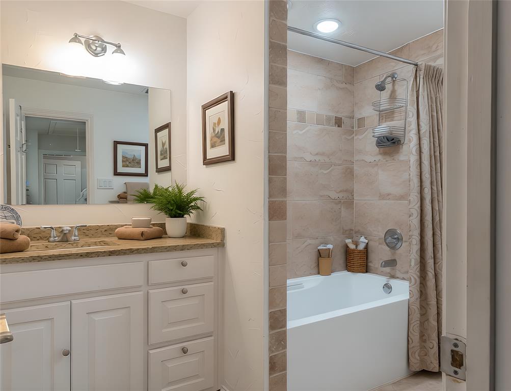 13 Crestview Circle Rockwall, TX 75087 - Photo 33 of 37 a bathroom with a sink a large mirror and shower