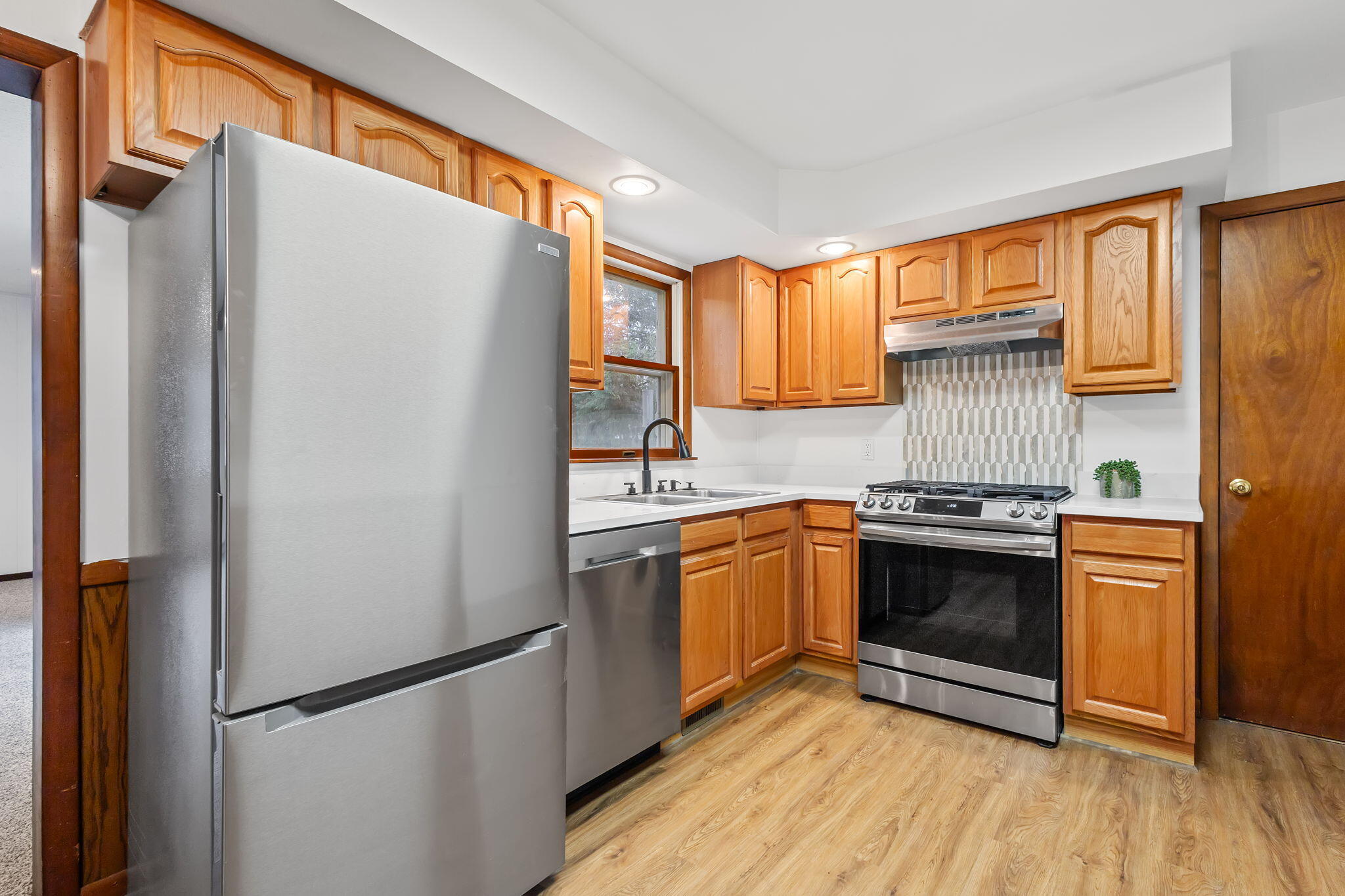 708 East Maple Street Rensselaer, IN 47978 - Photo 11 of 33 a kitchen with stainless steel appliances granite countertop a refrigerator stove and sink