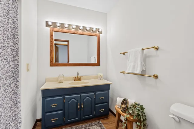 a bathroom with a sink vanity and mirror