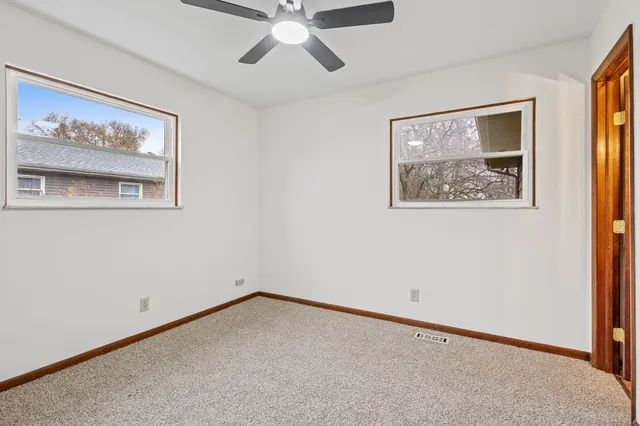 a view of an empty room with a painting on the wall
