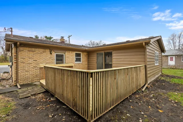 a view of a house with wooden fence
