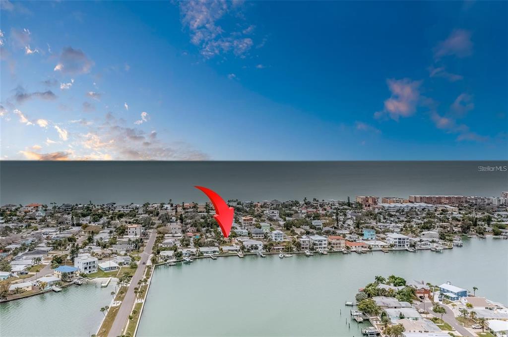 16108 Redington Drive Redington Beach, FL 33708 - Photo 7 of 13 view of a lake with boats and trees in the background
