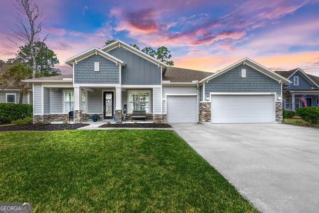 a front view of a house with yard patio and green space