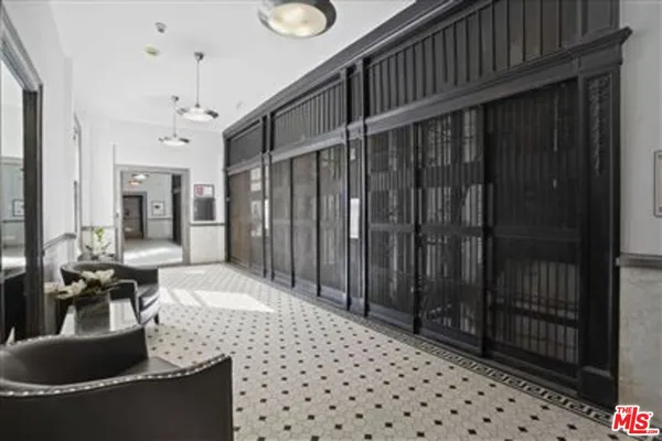 a hallway with a large window and wooden floor