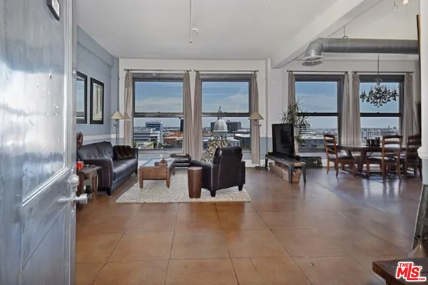 a living room with furniture large window and table